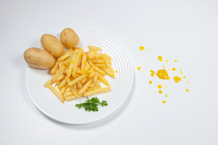 Delicious french fries inside a dish on top of a white background