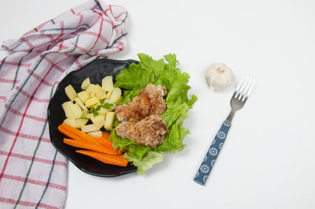 Beautiful salad dish with potato, carrot, lettuce and breaded chickenの写真素材