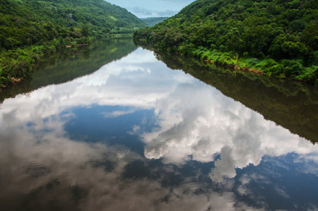 Reflection of clouds in a riverの写真素材