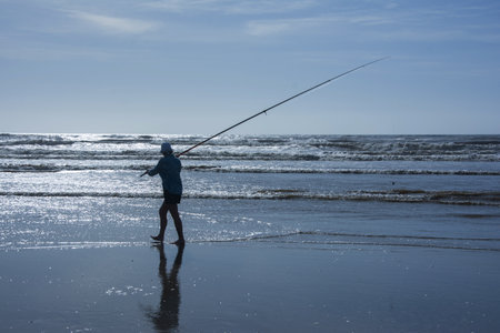 Old lady fishing on the seafrontの写真素材