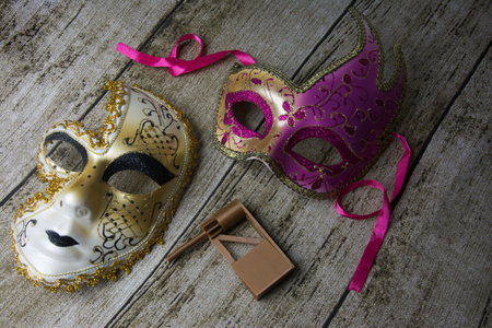 mask and gift box on wooden background.の写真素材