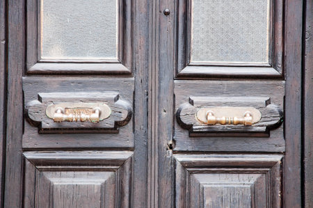 Old wooden door with handle and door knocker in uruguayの写真素材