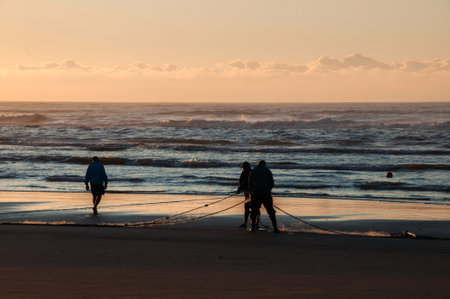 Fishermen on the beach at sunset, Arroio do Sal, Brazil