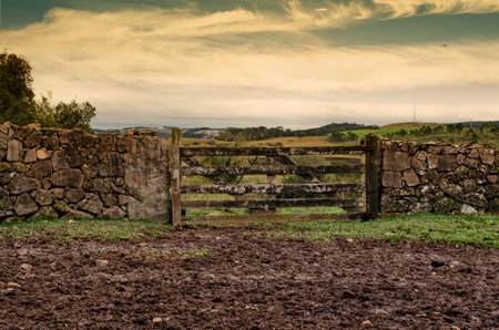 Old farm gate in the countryside on a cloudy day.の写真素材