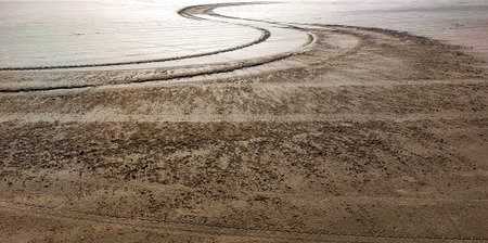 Take tracks on the beach at low tide. Toned.