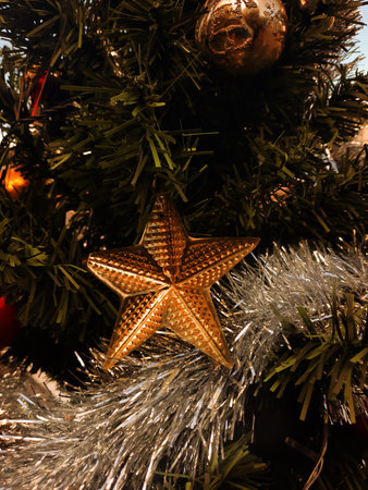 Christmas tree decoration with golden star on it, closeup of photo