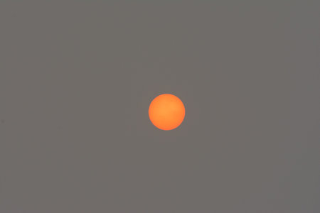 Red sun due to smoke from firesの写真素材