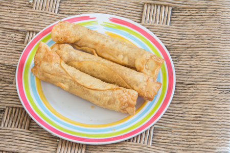Fried spring rolls with sausage in a plate on the table