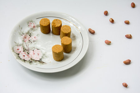 PaÃ§oca, peanuts and crackers on a white background. Close-up.