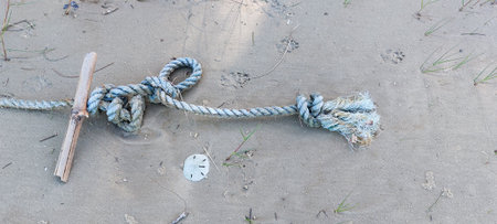 Rope tied with a rope on the beach. Close-up.