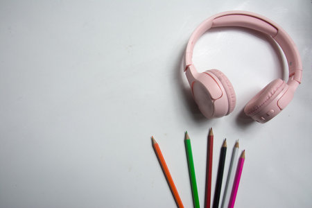 Pink headphone and color pencil on white background with copy space for text.の写真素材