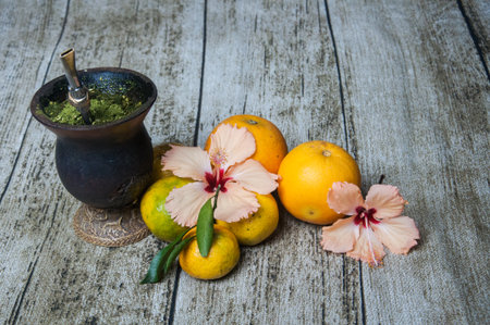 orange and hibiscus flower on wooden background