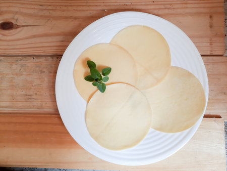Cheese collection, round shape of Brie cheese on white plateの写真素材