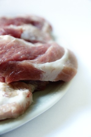 Raw Pork Shoulder Blade Meat at the white plateの写真素材