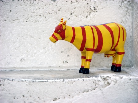 Yellow Cow on the stairs in Mykonos -  wooden handicraftの写真素材