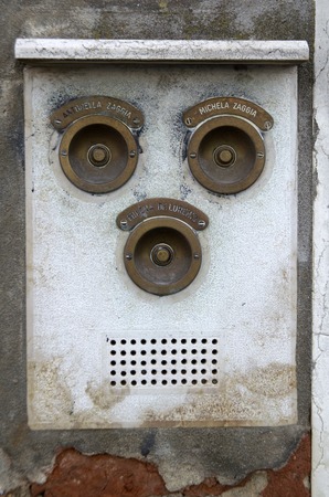 Antique Stone Door Bell Intercom with lion heads in Veniceの写真素材