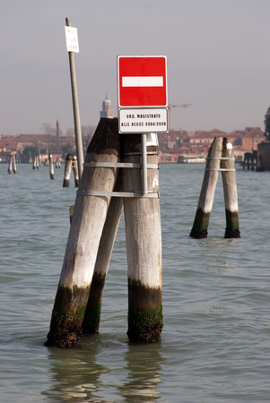 Water traffic sign board above the water in Venice, Italyの写真素材