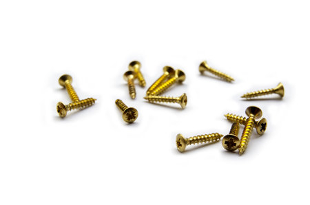 Golden Brass Screws With a Philips Crosshead Isolated On White