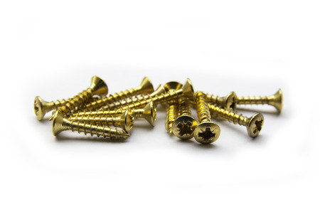 Golden Brass Screws With a Philips Crosshead Isolated On Whiteの写真素材