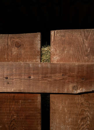 Hay in the shed. Wooden door locked.の写真素材