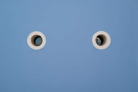 Blue wall and white eyes circle.の写真素材