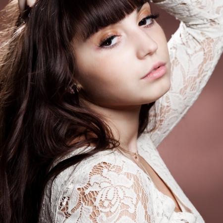 a pretty girl with chocolate hair over brown の写真素材