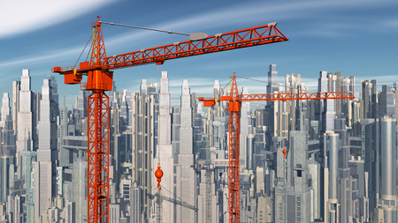 Construction cranes in front of a city landscapeの写真素材