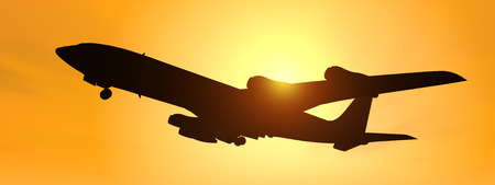 Silhouette of an airliner against a yellow sky