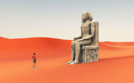 Statue from ancient Egypt in a sandy desert and discovererの写真素材