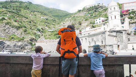 Father and two sons appreciating a beautiful mountain viewの写真素材