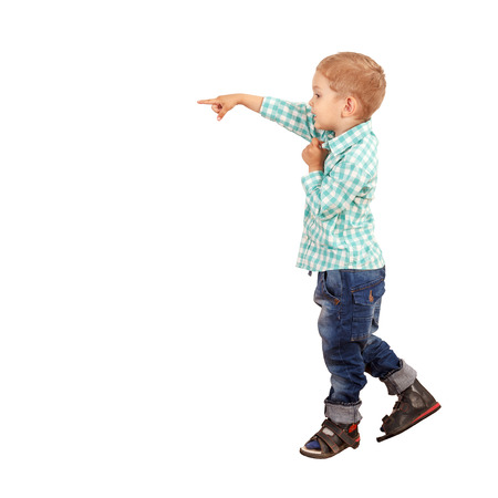 Little boy pointing away isolated on whiteの写真素材
