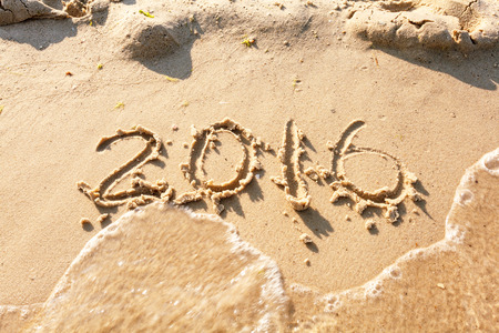 2016 written in sand, on tropical beach