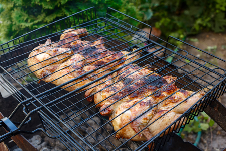 flat chicken on the grill at a green lawnの写真素材