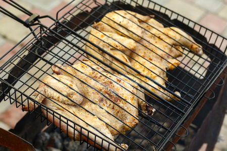 flat chicken on the grill at a green lawnの写真素材