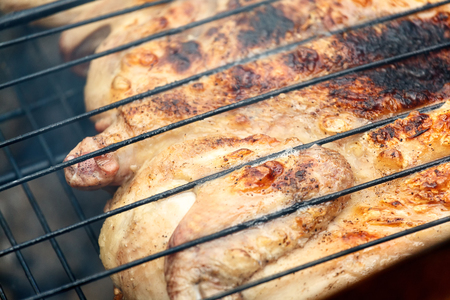 flat chicken on the grill at a green lawnの写真素材