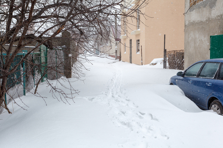 A street in Odessa after a snow storm. Cars and buildings can be seenの写真素材