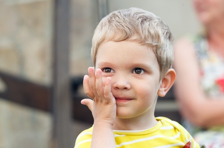 portrait of a smiling blond boy with brown eyesの写真素材