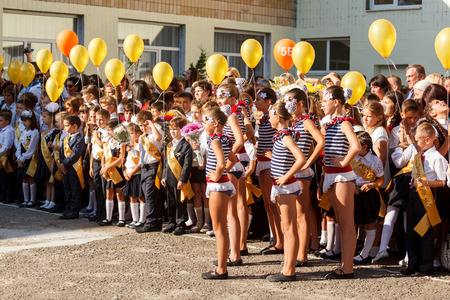 Odessa, Ukraine - September 1, 2015: School line is in schoolyard with first-grade pupils and teacher. Children go back to school. The Knowledge Day in Ukraine, School dance group.のeditorial素材