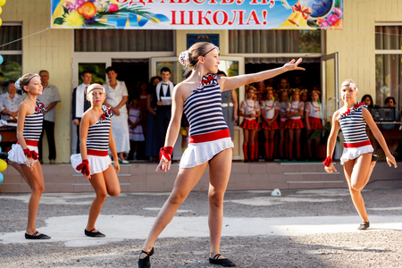 Odessa, Ukraine - September 1, 2015: School line is in schoolyard with first-grade pupils and teacher. Children go back to school. The Knowledge Day in Ukraine, School dance group.のeditorial素材