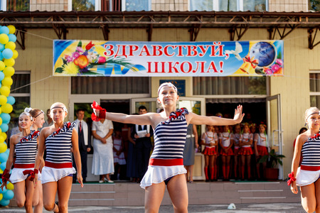 Odessa, Ukraine - September 1, 2015: School line is in schoolyard with first-grade pupils and teacher. Children go back to school. The Knowledge Day in Ukraine, School dance group.のeditorial素材