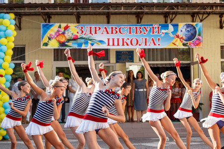 Odessa, Ukraine - September 1, 2015: School line is in schoolyard with first-grade pupils and teacher. Children go back to school. The Knowledge Day in Ukraine, School dance group.のeditorial素材