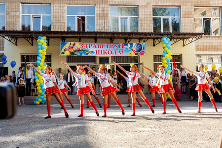 Odessa, Ukraine - September 1, 2015: School line is in schoolyard with first-grade pupils and teacher. Children go back to school. The Knowledge Day in Ukraine, School dance group.のeditorial素材