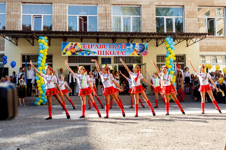 Odessa, Ukraine - September 1, 2015: School line is in schoolyard with first-grade pupils and teacher. Children go back to school. The Knowledge Day in Ukraine, School dance group.のeditorial素材