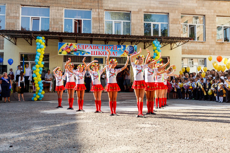 Odessa, Ukraine - September 1, 2015: School line is in schoolyard with first-grade pupils and teacher. Children go back to school. The Knowledge Day in Ukraine, School dance group.のeditorial素材