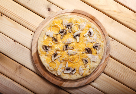 Italian pizza with  onion, ham, bacon, mushrooms  and olivesの写真素材