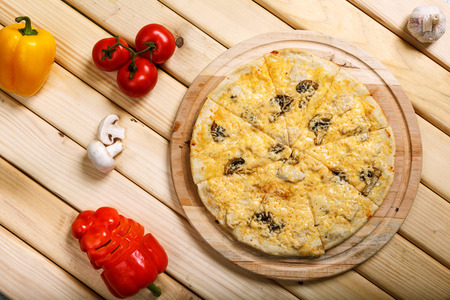 Italian pizza with onion, ham, bacon, mushrooms and olivesの写真素材