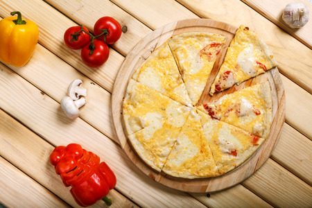 Pizza on light wooden background top view. Thin pastry crust on wooden deskの写真素材