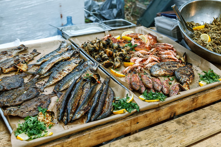 Grilled fish, shrimp, mussels and seafood, lemon and basil. Street foodの写真素材