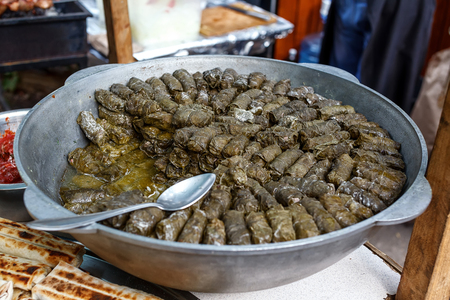 Dolma, greek traditional appetizer in cauldron. Selective focus stuffed vine leavesの写真素材
