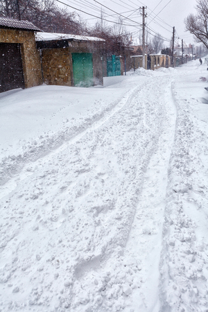 Snow storm hits town. Street after snow blizzardの写真素材